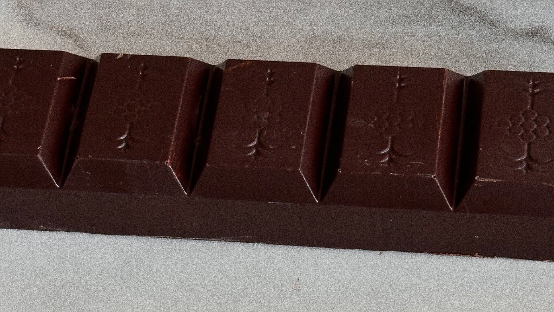 Chocolate bar with a mild addictions pattern on a gray surface